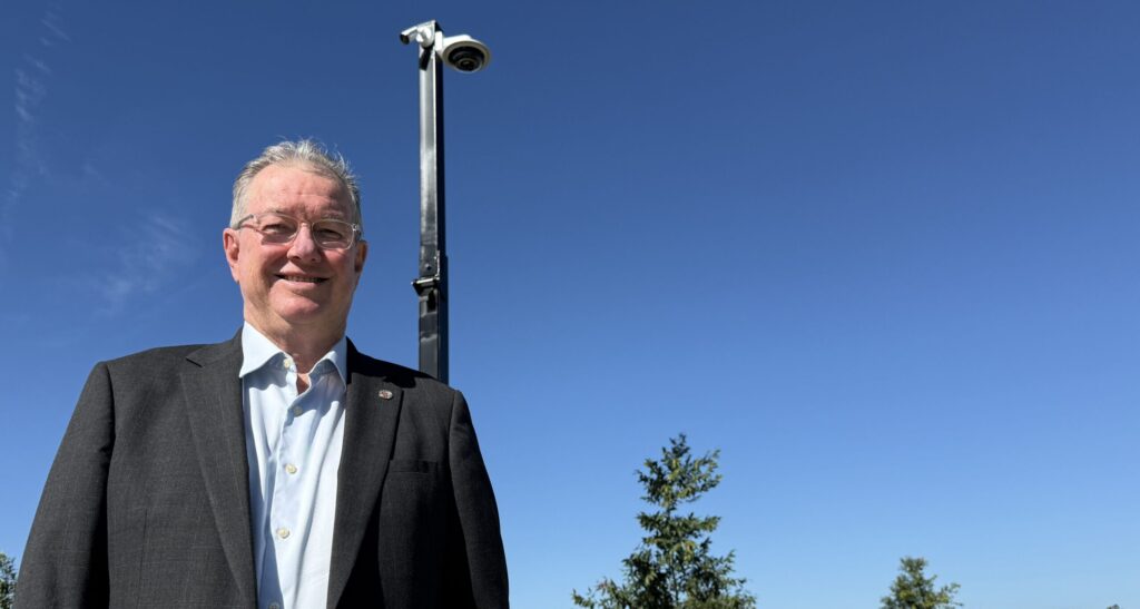 Mayor Peter Flannery in front one of the new CCTV camera poles going into new housing estates. Photo: Moreton Bay City Council