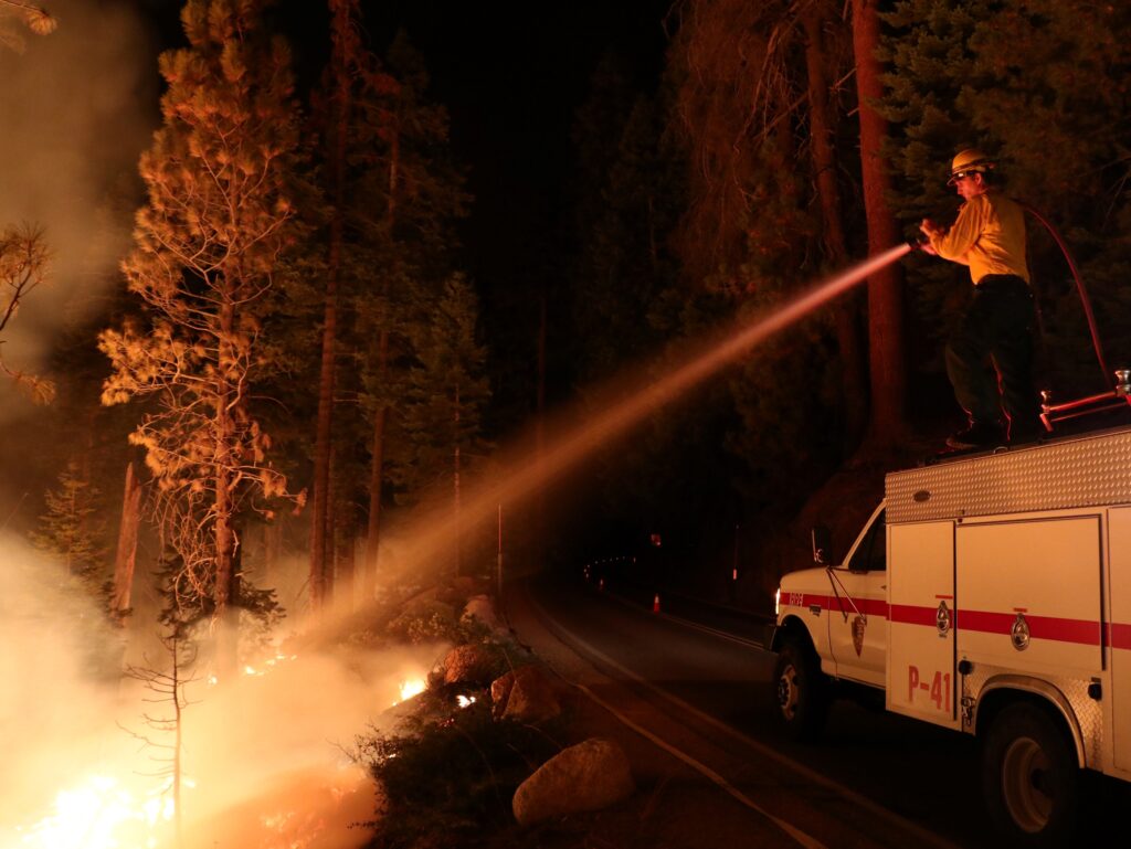 fresh ... A wildland firefighter cools the edge of a prescribed burn during a night shift. Photo: FILE/ Rebecca Paterson/DOI-USWFS