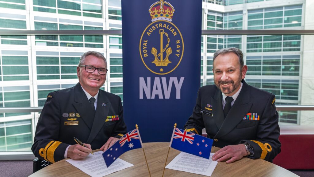 trans-tasman ... RAN deputy chief Rear Admiral Darren Grogan (left) and RNZ Navy Deputy Commodore Karl Woodhead sign the deal in Canberra. Photo: Department of Defence.