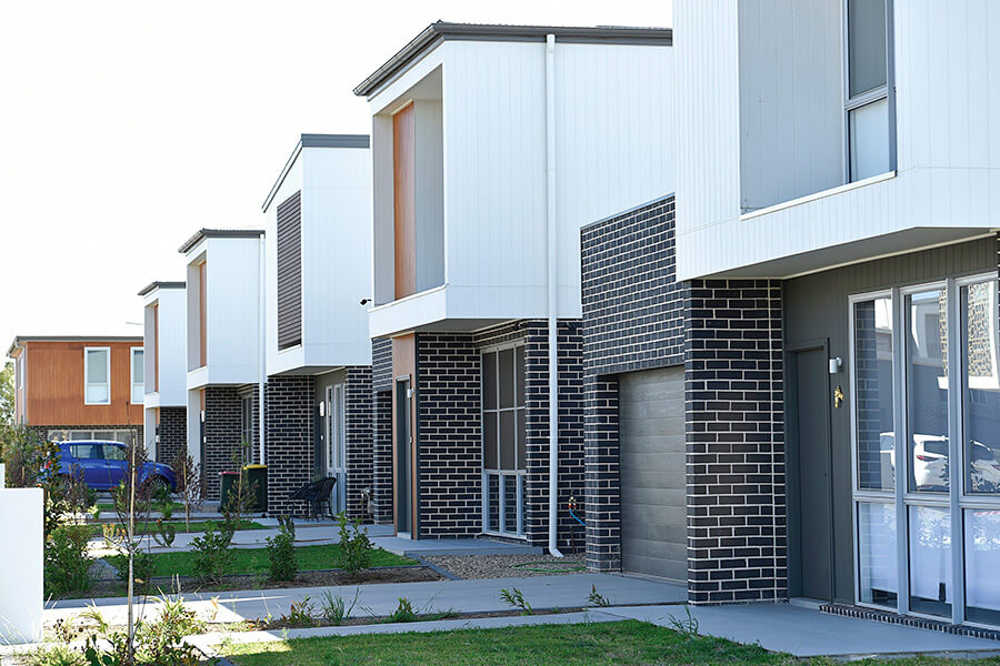 Row of new townhouses on a suburban street, illustrating the ACT Planning Act changes