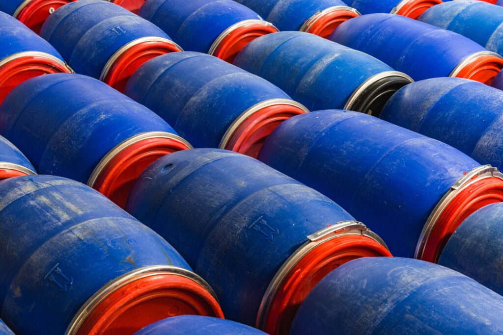 Rows of blue plastic drums with red lids, illustrating hazardous materials in South Australia
