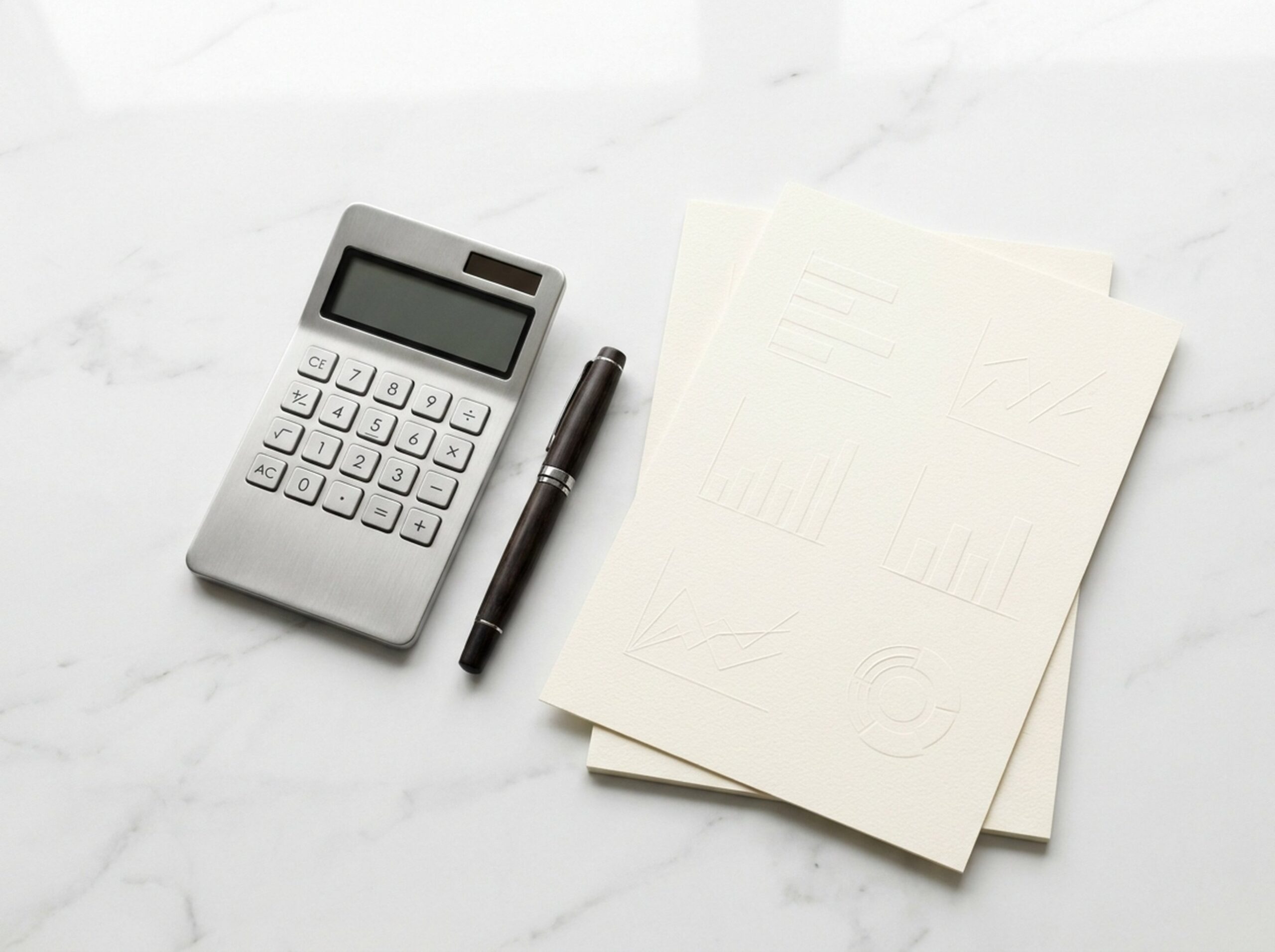 Calculator, pen and paper with charts on a marble desk, illustrating NDIS pricing schedules