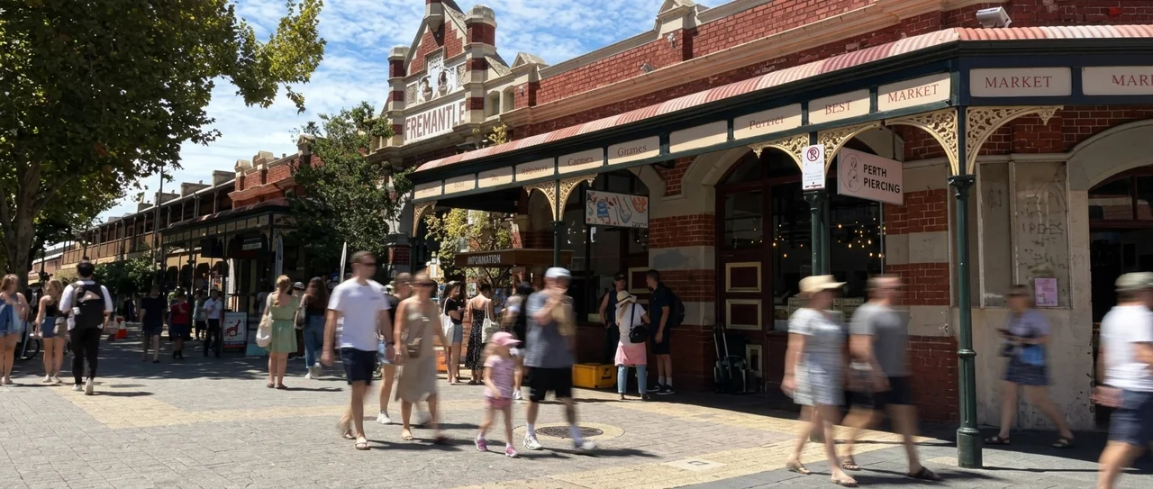 Shoppers walking past market buildings in Fremantle, retail barring orders