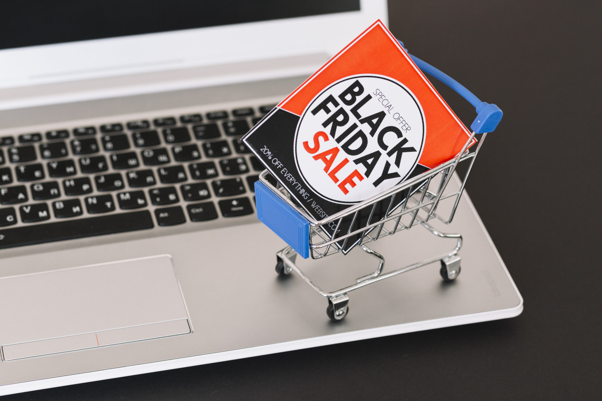 Miniature shopping trolley holding a Black Friday sale sign on a laptop, illustrating the James Lane and Vuly Black Friday sale claims