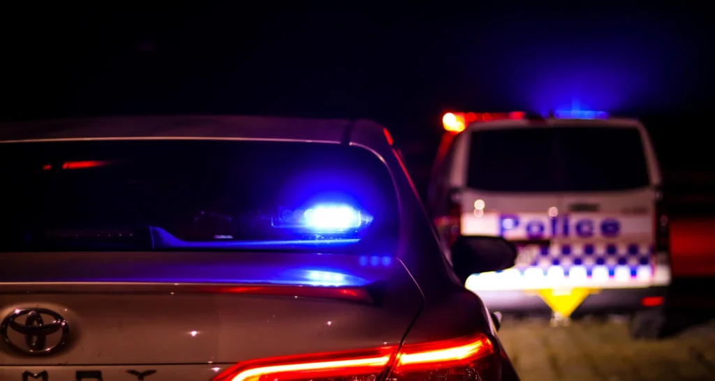 Police car lights at night after the Loganholme shooting