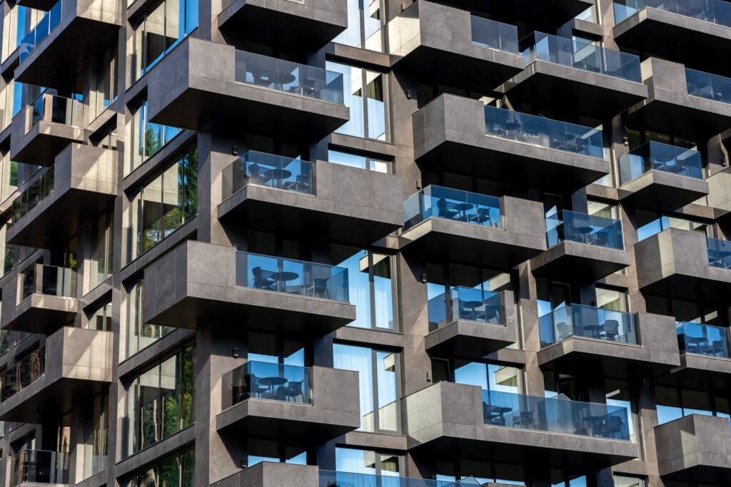 Modern apartment balconies with glass balustrades, NSW strata reform
