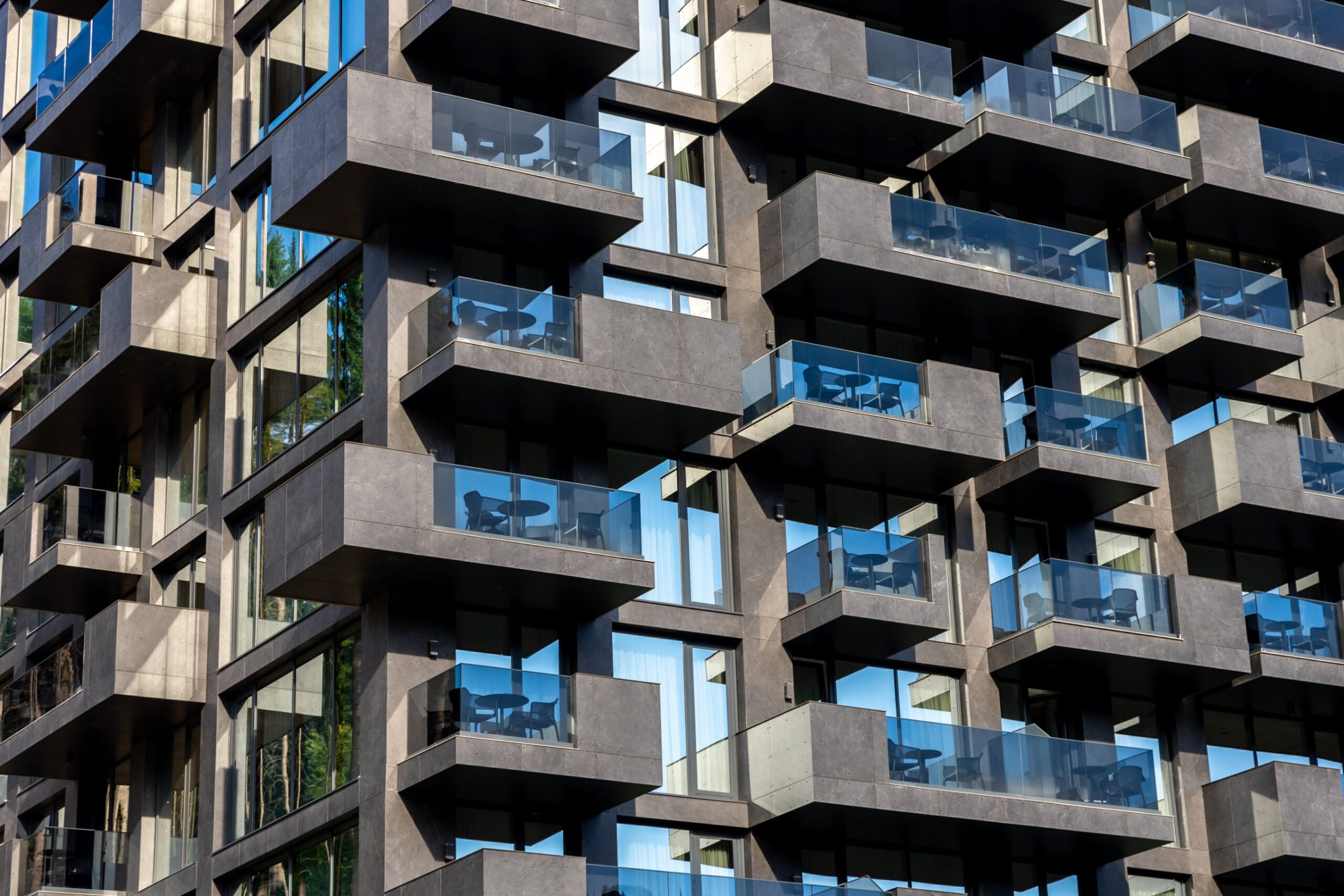 Modern apartment balconies with glass balustrades, NSW strata reform