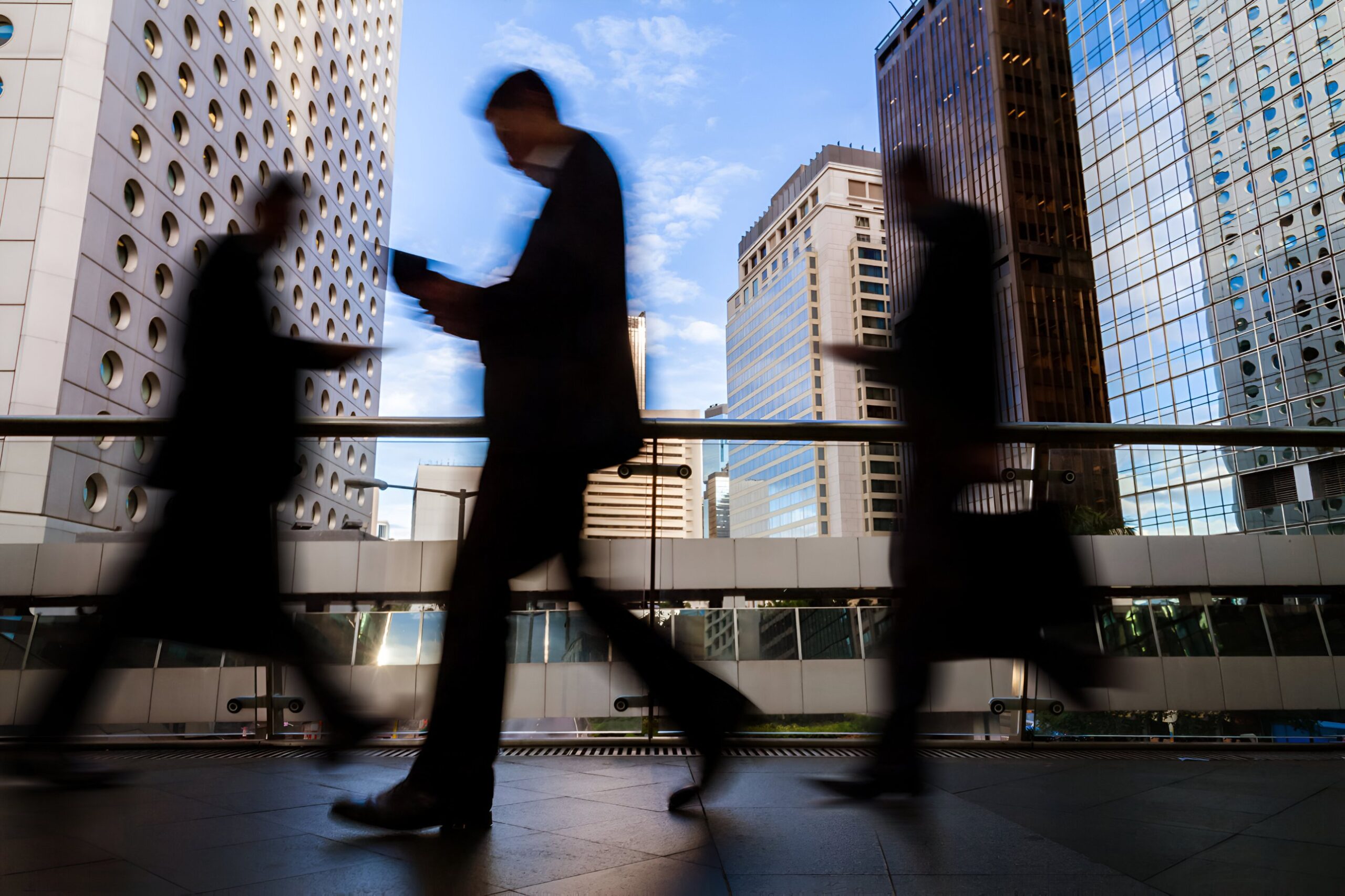 People walking past city office buildings, mutual obligation payment suspensions