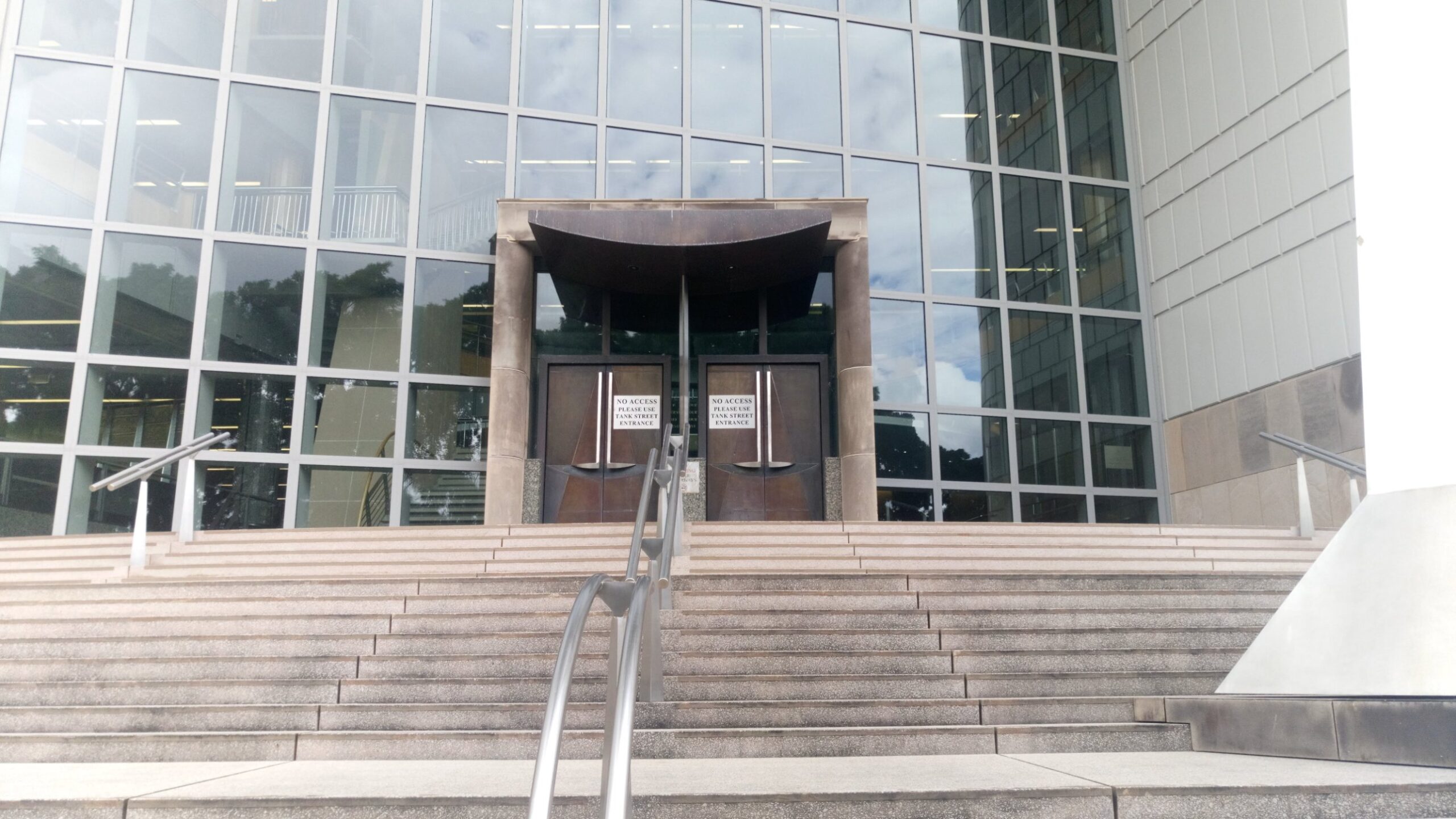 Harry Gibbs Commonwealth Law Courts Building entrance steps in Brisbane, Queensland circuit breaker story