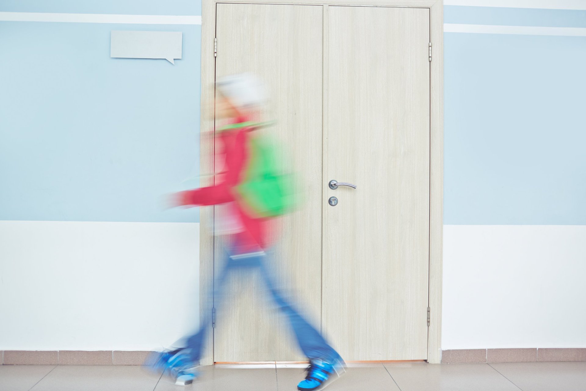 Person walking past a closed door in a corridor, illustrating rooming house records