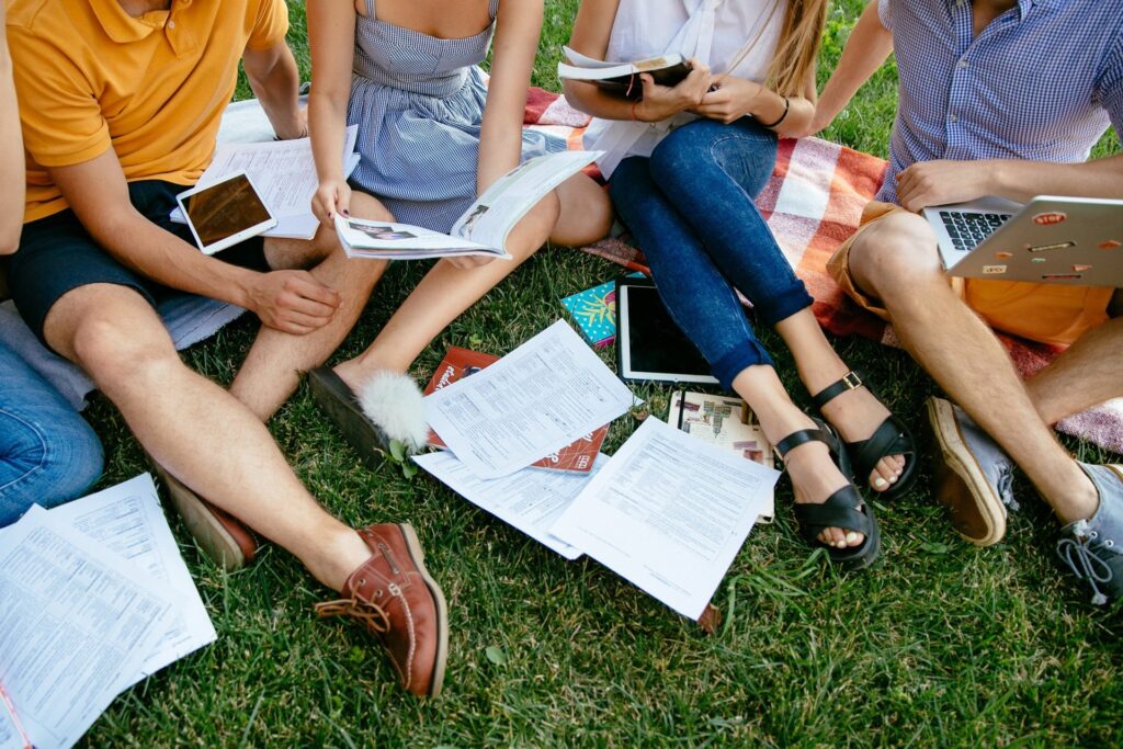 University students studying on the grass, as the National Student Ombudsman levy takes effect