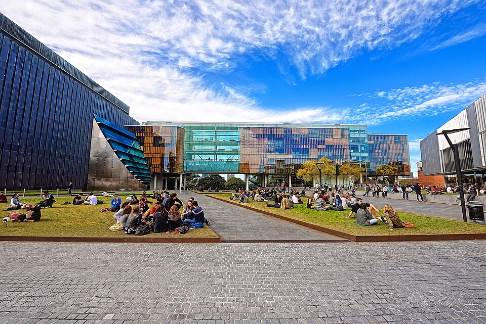 Students sitting on the lawns of a Sydney university campus, university funding reforms